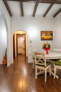 comedor con mesa, sillas y guitarra en Accogliente intero appartamento, en Roma