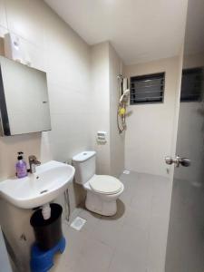 a white bathroom with a toilet and a sink at Solace R3 SetiaWalk Pusat Bandar puchong in Puchong