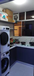 una cucina con lavatrice e piano cottura di Solace R3 SetiaWalk Pusat Bandar puchong a Puchong