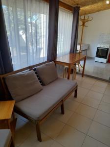 a living room with a couch and a table at Gîte chez Cécile dans le Luberon in Lagnes