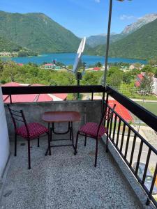 a table and two chairs on a balcony with a view at Linden apartment in Pluzine