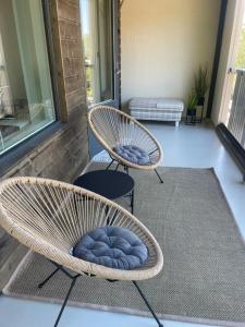 two wicker chairs sitting on a porch at Condo in the heart of Katariina, near Kotka City Center! in Kotka