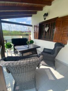 a balcony with a table and chairs on a patio at M&B Luxury House in Theologos
