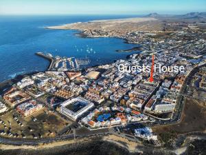 an aerial view of a city with the words guest house at The Spot House in Corralejo