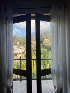 an open window with a view of a mountain at Morfeas Kakopetria in Kakopetria