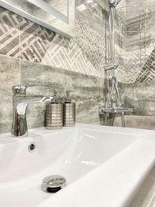 a white sink with a faucet in a bathroom at Great 2BDR Apartment in the Centre for 6 Guests in Stara Zagora +56 photos