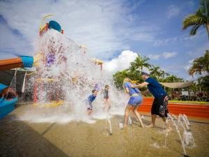 a group of people playing in a water park at Kurrimine Beach Holiday Park in Kurrimine Beach