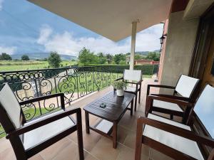 a balcony with chairs and a table and a railing at Casa con jardin - El Magnolio 7802 in Castillo