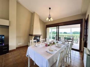 a dining room with a table and a fireplace at Casa con jardin - El Magnolio 7802 in Castillo +7 photos