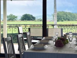 a table with plates and wine glasses on a balcony at Casa con jardin - El Magnolio 7802 in Castillo