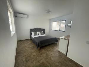 a bedroom with a bed and a window at Casa Ryn in Vama Veche