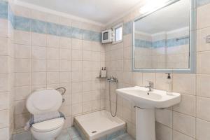 a bathroom with a toilet and a sink at Erifili Kallithea in Kallithea Halkidikis