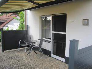 a patio with a table and chairs next to a building at Appartementhaus Zur schönen Aussicht in Bad Abbach