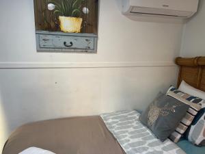 a bedroom with a bed and a window with a plant at XYL Pets Friendly Opened Spacious Seaside Boutique Guesthouse in Caloundra