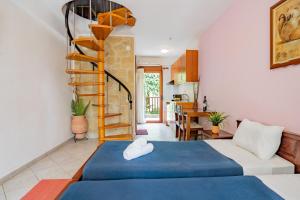 a bedroom with a blue bed and a spiral staircase at Erifili Kallithea in Kallithea Halkidikis