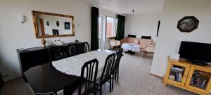 a kitchen and living room with a table and chairs at Ægisholt privete house with hot tub in Patreksfjörður