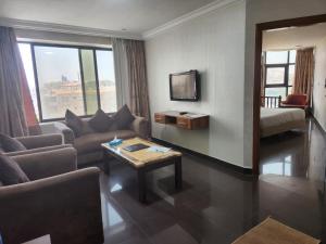 a living room with a couch and a table at Amman Orchid Hotel in Amman