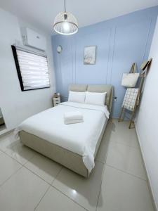 a bedroom with a large bed and a blue wall at Sea view penthouse Private rooftop jacuzzi in Eilat