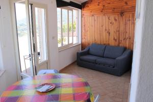 a living room with a table and a couch at Appartamenti Miramare in Collina in Ischia