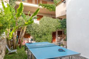 a blue table in front of a building with plants at Erifili Kallithea in Kallithea Halkidikis