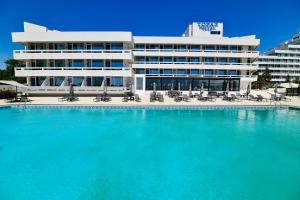 a large swimming pool in front of a building at HOTEL TOPAZ 4* CAP AURORA in Cap Aurora