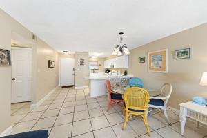 a dining room and kitchen with a table and chairs at Seaside Beach & Racquet 2105 in Orange Beach +30 photos