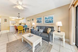 a living room with a couch and a table at Seaside Beach & Racquet 2105 in Orange Beach