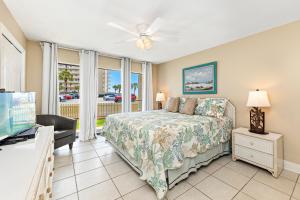 a bedroom with a bed and a flat screen tv at Seaside Beach & Racquet 2105 in Orange Beach
