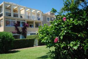 a large building with roses in front of it at La Adela in Denia
