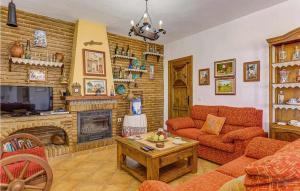 a living room with a couch and a fireplace at Aranzazu in Frigiliana
