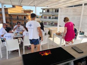 a group of people sitting at a table on a balcony at La Piazza BeB in Tropea +51 photos