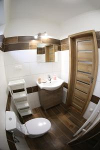 a bathroom with a toilet and a sink at Dom Marhuľa in Štúrovo