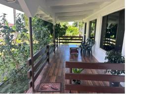 une terrasse couverte avec des bancs et des chaises sur une maison dans l'établissement Bula Homestay, à Labasa