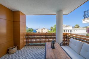 un balcón con un sofá blanco en una terraza de madera en Lupia Suites, en Kalkan