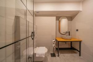 a bathroom with a sink and a mirror at Lupia Suites in Kalkan