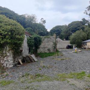 a stone building with a pile of wooden pallets next to it at Lovely 4-bed property in Mullaghbawn in Meigh