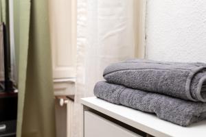 a stack of towels on a shelf in a bathroom at Home City Center Terrace Apartment in Budapest