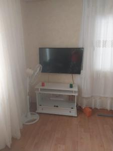 a flat screen tv sitting on top of a white entertainment center at VİLLAGE GARDEN APART in Kemer