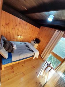 a bedroom with a bed in a wooden room at Beachouse in Lock Sport
