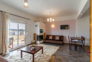 a living room with a couch and a table at Erifili Kallithea in Kallithea Halkidikis