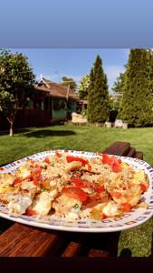 a plate of food on top of a table at Pensiunea Doina și Ion in Mileştii Mici