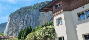 a building with a view of a waterfall at Studio Inferno Lauterbrunnen in Lauterbrunnen