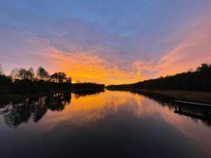a view of a river at sunset at Apartament G66 in Wydminy