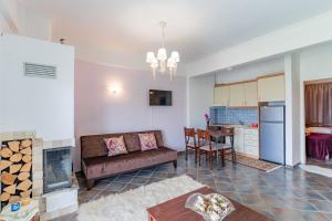 a living room with a couch and a fireplace at Erifili Kallithea in Kallithea Halkidikis