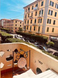 a balcony with a chair and buildings in the background at Appartamento retrò-chic in La Spezia in La Spezia