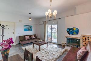 a living room with a couch and a fireplace at Erifili Kallithea in Kallithea Halkidikis