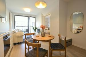a dining room and living room with a table and chairs at Green Estate Old Town Apartment, private parking, balcony in Gdańsk