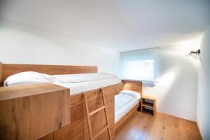 - une petite chambre avec un lit et une fenêtre dans l'établissement Villa Mayr, à Ortisei