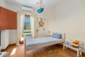 Postel nebo postele na pokoji v ubytování SUN VILLA GLYFADA