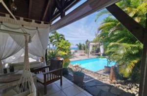 a view from the patio of a villa with a swimming pool at Ali-Naïs Location in Deshaies